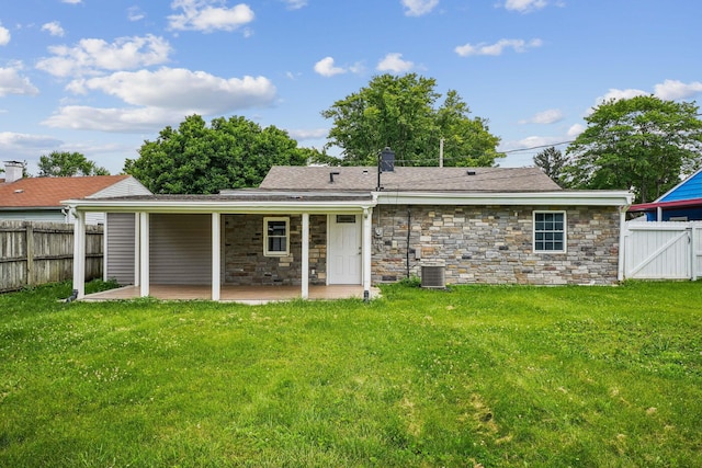 4425 Saint Ann Ln, Columbus, OH 43213 - rear view of property with a patio area, a fenced backyard, stone siding, and a gate