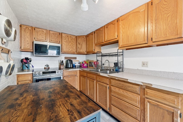 67 W Columbus St, Mount Sterling, OH 43143 - kitchen with appliances with stainless steel finishes, wood counters, and a textured ceiling