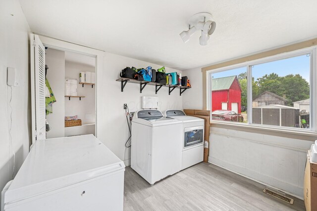 67 W Columbus St, Mount Sterling, OH 43143 - laundry room with independent washer and dryer and light wood-style flooring