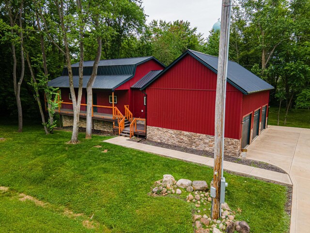 7326 State Route 19 Unit 8, Lots 255-257, Mount Gilead, OH 43338 - view of front facade with a front lawn, stone siding, a metal roof, a porch, and a garage