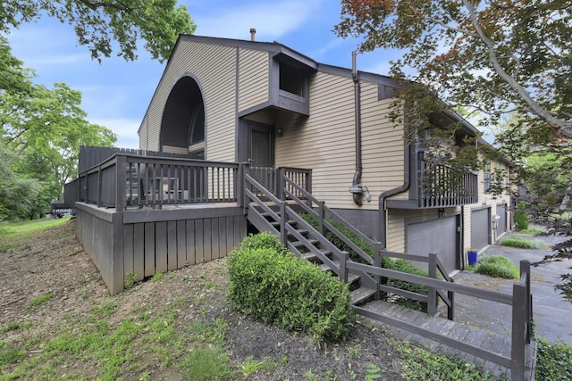 3117 Rivermill Dr Unit 25, Columbus, OH 43220 - rear view of property featuring stairs, an attached garage, and a deck