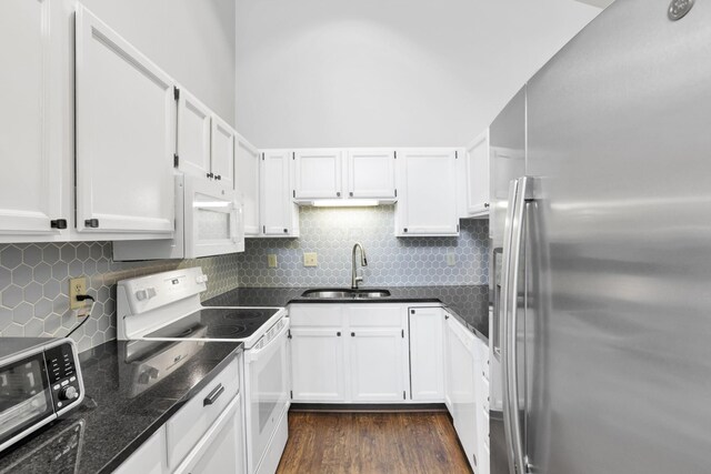 3117 Rivermill Dr Unit 25, Columbus, OH 43220 - kitchen with appliances with stainless steel finishes, white cabinetry, dark wood finished floors, and backsplash