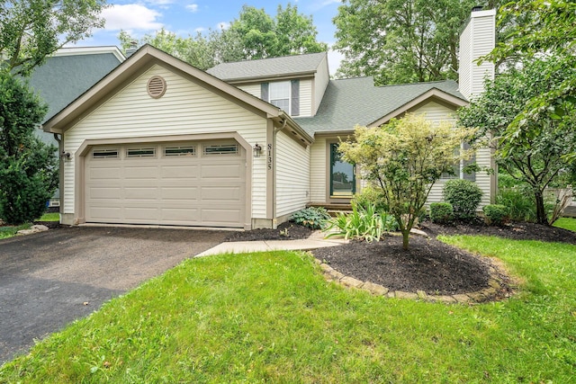 8135 Barlow Rd, Westerville, OH 43081 - view of front facade with a garage, driveway, a front yard, and a shingled roof
