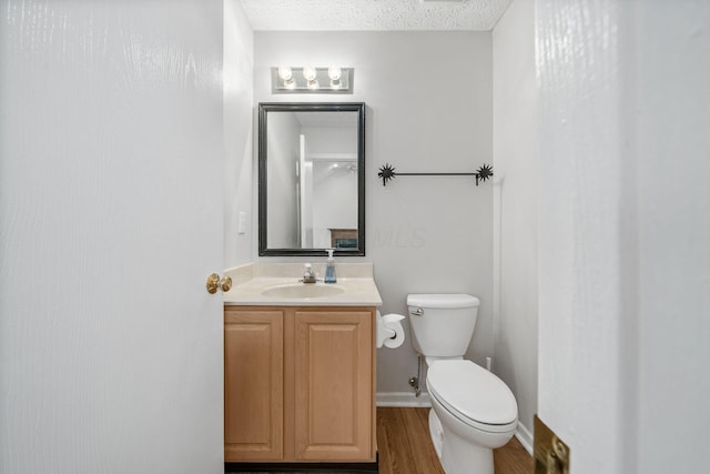 8135 Barlow Rd, Westerville, OH 43081 - half bathroom with vanity, wood finished floors, and a textured ceiling