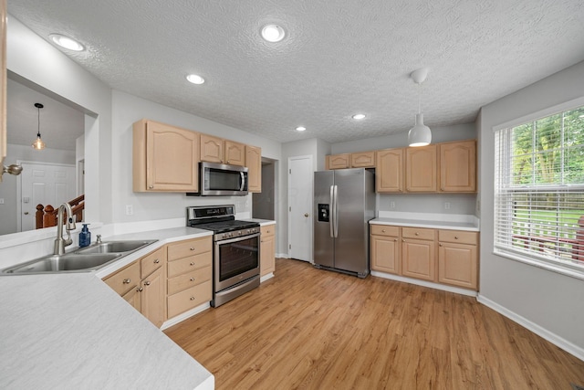 8135 Barlow Rd, Westerville, OH 43081 - kitchen featuring appliances with stainless steel finishes, light brown cabinetry, light wood-style flooring, light countertops, and a textured ceiling