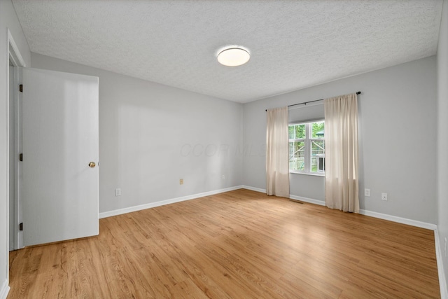 8135 Barlow Rd, Westerville, OH 43081 - empty room with light wood finished floors and a textured ceiling