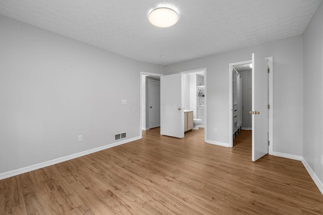 8135 Barlow Rd, Westerville, OH 43081 - unfurnished bedroom with light wood finished floors, ensuite bath, and a spacious closet