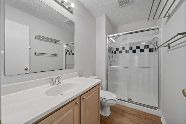 8135 Barlow Rd, Westerville, OH 43081 - full bathroom featuring a shower stall, wood finished floors, vanity, and a textured ceiling