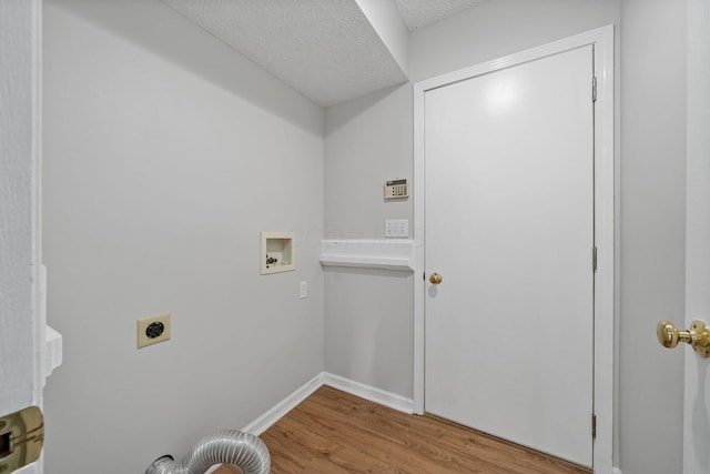 8135 Barlow Rd, Westerville, OH 43081 - laundry area with hookup for an electric dryer, wood finished floors, hookup for a washing machine, and a textured ceiling