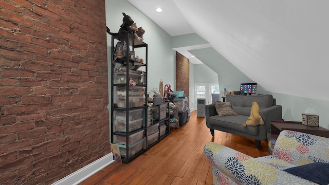 737 Wilson Ave, Columbus, OH 43205 - living area featuring brick wall, wood-type flooring, and lofted ceiling