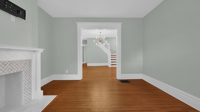 737 Wilson Ave, Columbus, OH 43205 - unfurnished living room featuring a chandelier and wood finished floors