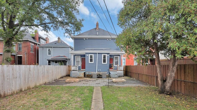 737 Wilson Ave, Columbus, OH 43205 - back of house featuring a fenced backyard, a chimney, and a patio area
