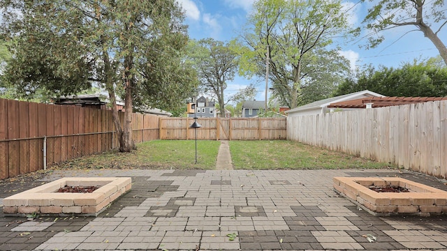 737 Wilson Ave, Columbus, OH 43205 - fenced backyard featuring an outdoor fire pit and a patio area