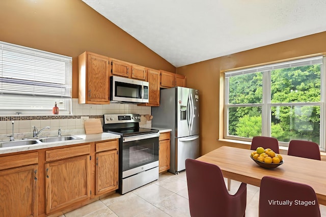 3576 Blendon Bend Way, Columbus, OH 43231 - kitchen with appliances with stainless steel finishes, tasteful backsplash, vaulted ceiling, light countertops, and light tile patterned floors