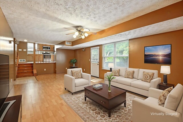 3576 Blendon Bend Way, Columbus, OH 43231 - living area with a textured ceiling, light wood-type flooring, stairs, and a ceiling fan