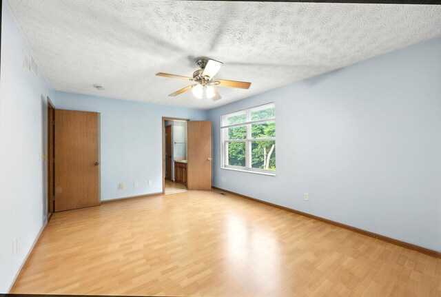 3576 Blendon Bend Way, Columbus, OH 43231 - unfurnished bedroom featuring light wood finished floors, a textured ceiling, ensuite bathroom, and ceiling fan