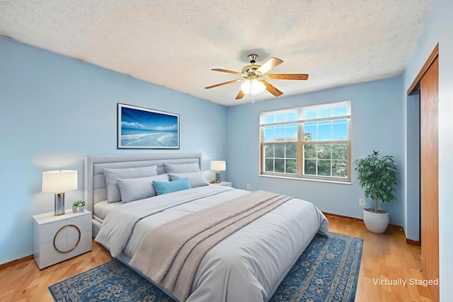 3576 Blendon Bend Way, Columbus, OH 43231 - bedroom featuring a textured ceiling, light wood finished floors, a ceiling fan, and a closet