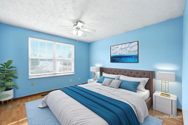3576 Blendon Bend Way, Columbus, OH 43231 - bedroom featuring wood finished floors, a ceiling fan, and a textured ceiling