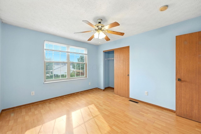 3576 Blendon Bend Way, Columbus, OH 43231 - unfurnished bedroom with light wood-type flooring, a textured ceiling, a closet, and a ceiling fan