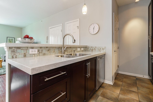 115 E Noble St Unit 2, Columbus, OH 43215 - kitchen featuring stainless steel dishwasher, a peninsula, light stone countertops, hanging light fixtures, and dark brown cabinets