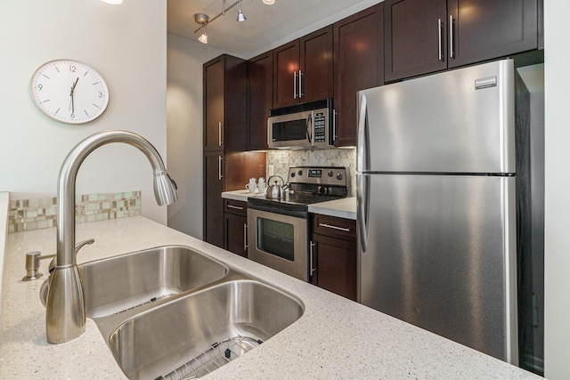 115 E Noble St Unit 2, Columbus, OH 43215 - kitchen with stainless steel appliances, dark brown cabinets, backsplash, and light stone countertops