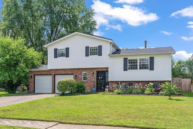 3221 E Hudson St, Columbus, OH 43219 - split level home with an attached garage, brick siding, and concrete driveway