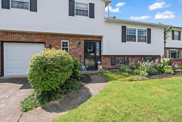 3221 E Hudson St, Columbus, OH 43219 - split level home featuring brick siding, a front lawn, driveway, stucco siding, and an attached garage