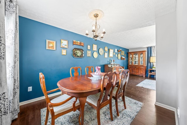 3221 E Hudson St, Columbus, OH 43219 - dining area with a textured ceiling, a chandelier, and dark wood-style flooring