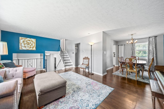3221 E Hudson St, Columbus, OH 43219 - living room featuring a chandelier, a textured ceiling, dark wood finished floors, and stairway