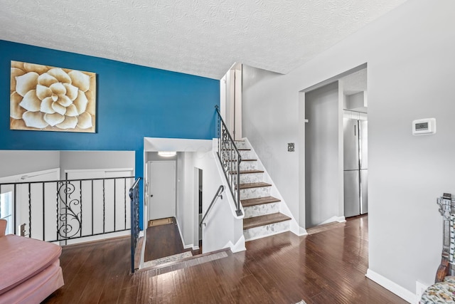 3221 E Hudson St, Columbus, OH 43219 - staircase featuring hardwood / wood-style flooring and a textured ceiling