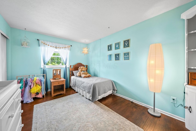 3221 E Hudson St, Columbus, OH 43219 - bedroom featuring wood finished floors and a textured ceiling