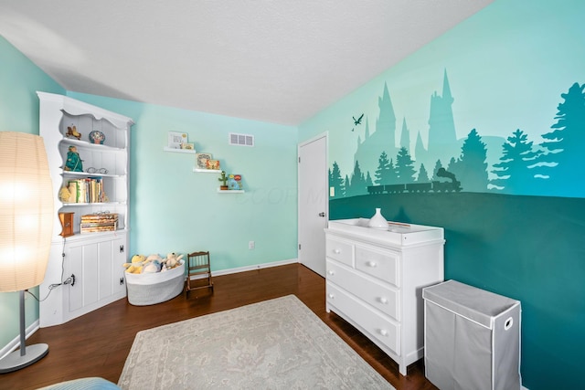 3221 E Hudson St, Columbus, OH 43219 - bedroom featuring dark wood-style flooring and baseboards