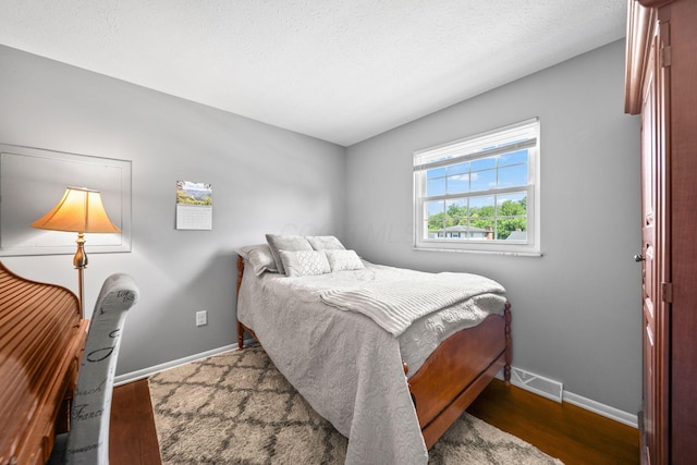 3221 E Hudson St, Columbus, OH 43219 - bedroom with baseboards and wood finished floors