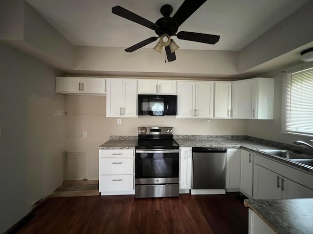 68 Moull St, Newark, OH 43055 - kitchen featuring stainless steel appliances, ceiling fan, dark wood-type flooring, white cabinets, and dark countertops