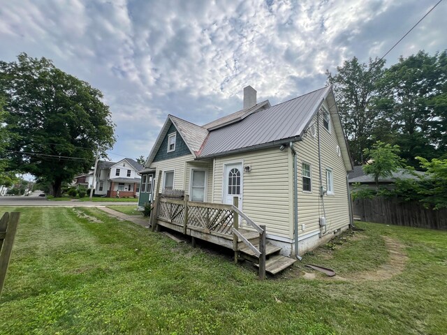 68 Moull St, Newark, OH 43055 - view of property exterior with a chimney, a metal roof, and a wooden deck