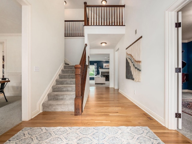 5808 Glendavon Loop, Dublin, OH 43016 - entryway featuring light wood finished floors, stairs, and a fireplace
