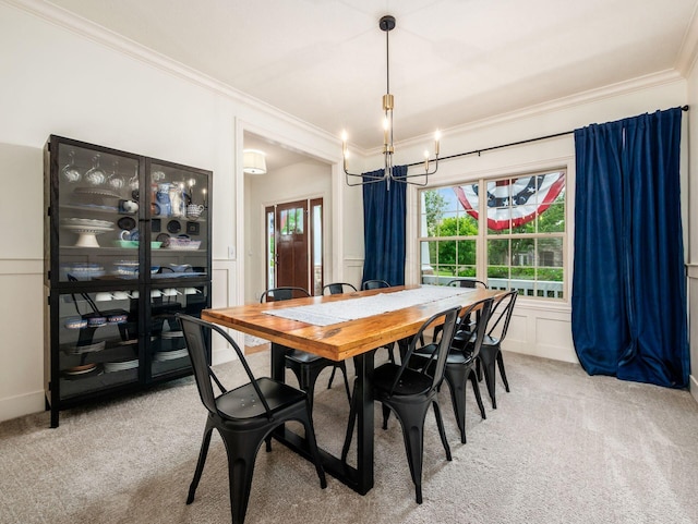 5808 Glendavon Loop, Dublin, OH 43016 - dining space with ornamental molding, light carpet, a chandelier, and a decorative wall