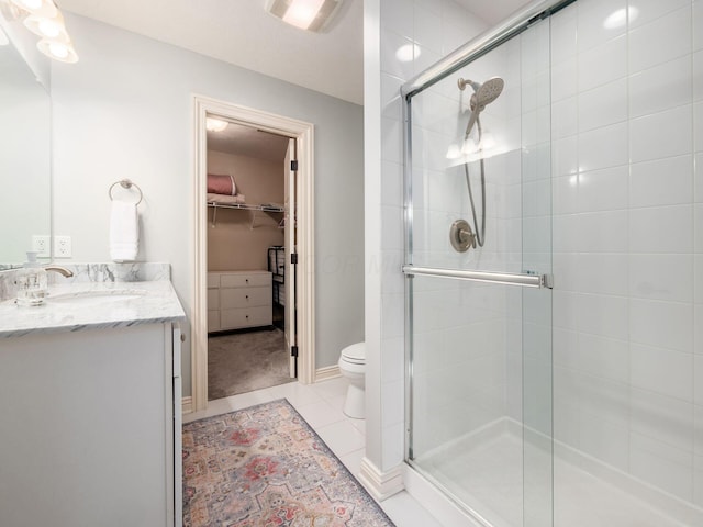5808 Glendavon Loop, Dublin, OH 43016 - bathroom with a spacious closet, vanity, a shower stall, and tile patterned floors