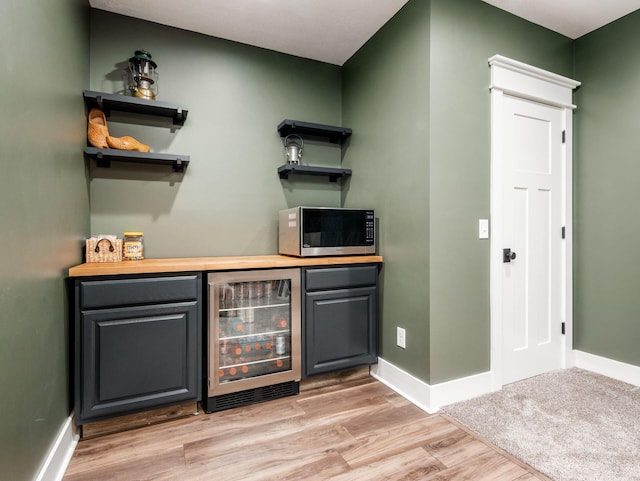 5808 Glendavon Loop, Dublin, OH 43016 - indoor dry bar with beverage cooler, stainless steel microwave, and light wood-type flooring