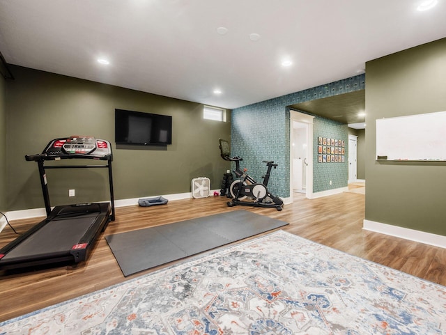 5808 Glendavon Loop, Dublin, OH 43016 - exercise area featuring wood finished floors, recessed lighting, an accent wall, and wallpapered walls