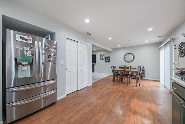 2986 E Powell Rd, Columbus, OH 43240 - kitchen with stainless steel fridge with ice dispenser, light wood-type flooring, recessed lighting, and light countertops