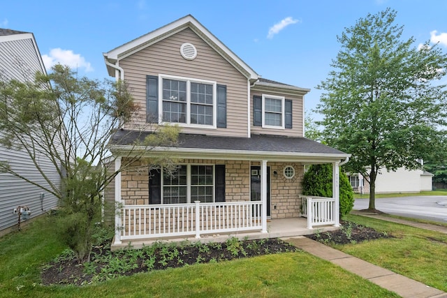 2986 E Powell Rd, Columbus, OH 43240 - traditional-style house with covered porch, a front yard, and stone siding