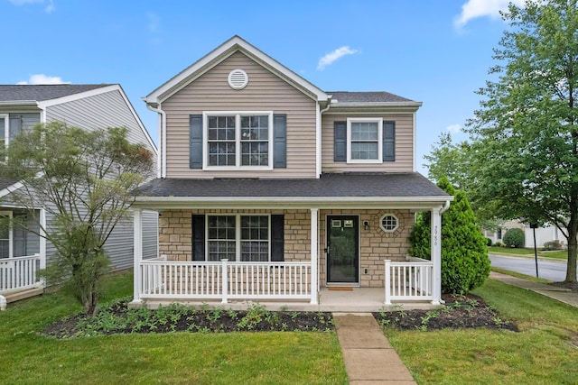 2986 E Powell Rd, Columbus, OH 43240 - traditional-style home featuring a porch, stone siding, a front lawn, and roof with shingles