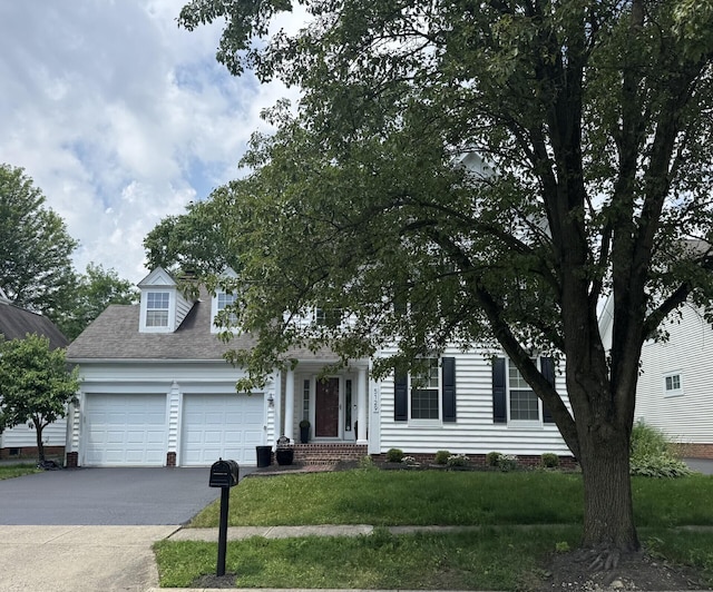 5129 Marks Ct, New Albany, OH 43054 - obstructed view of property featuring a garage, driveway, a front yard, and a shingled roof