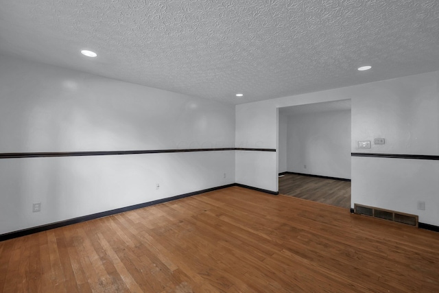 4974 Silverton Dr, Columbus, OH 43232 - unfurnished room with a textured ceiling, recessed lighting, and hardwood / wood-style flooring