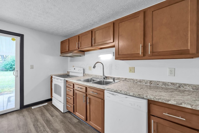 4974 Silverton Dr, Columbus, OH 43232 - kitchen with white appliances, under cabinet range hood, brown cabinets, dark wood-style floors, and light countertops