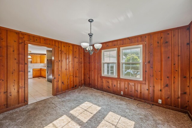 768 Barks Rd E, Marion, OH 43302 - empty room featuring wood walls, a chandelier, light colored carpet, and light tile patterned floors