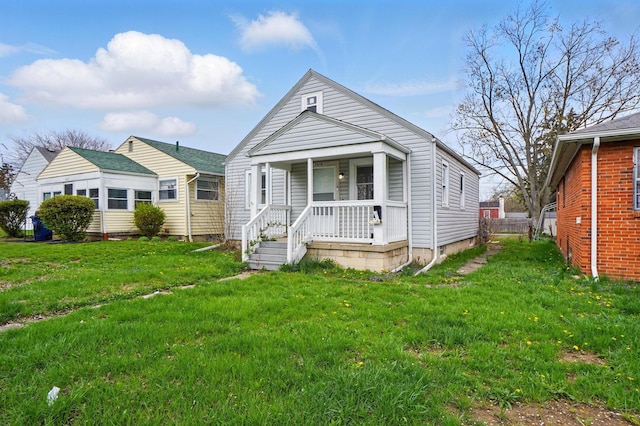 2678 Eakin Rd, Columbus, OH 43204 - shotgun-style home featuring a porch and a front lawn