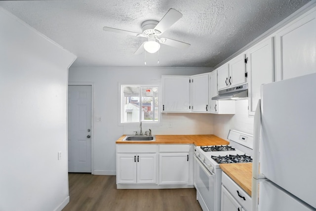 2678 Eakin Rd, Columbus, OH 43204 - kitchen featuring white appliances, under cabinet range hood, butcher block counters, dark wood-type flooring, and tasteful backsplash