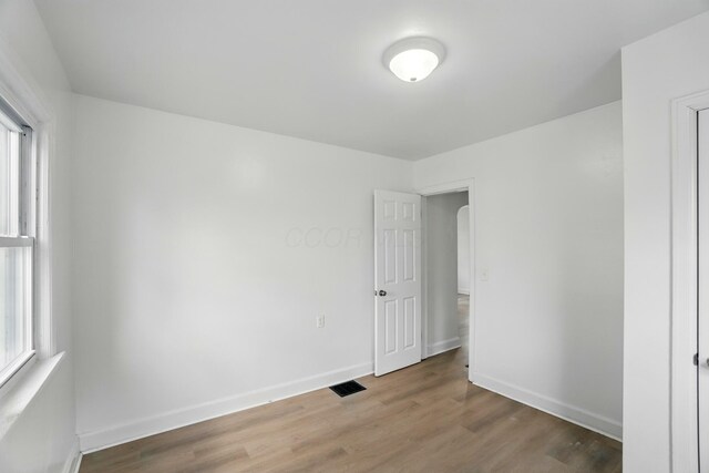 2678 Eakin Rd, Columbus, OH 43204 - empty room with wood finished floors and arched walkways